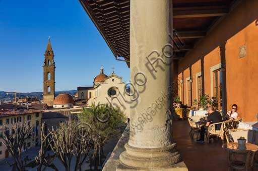 Aerial view of Piazza Santo Spirito in Florence from the historic loggia of Palazzo Guadagni with tourists sitting at tables