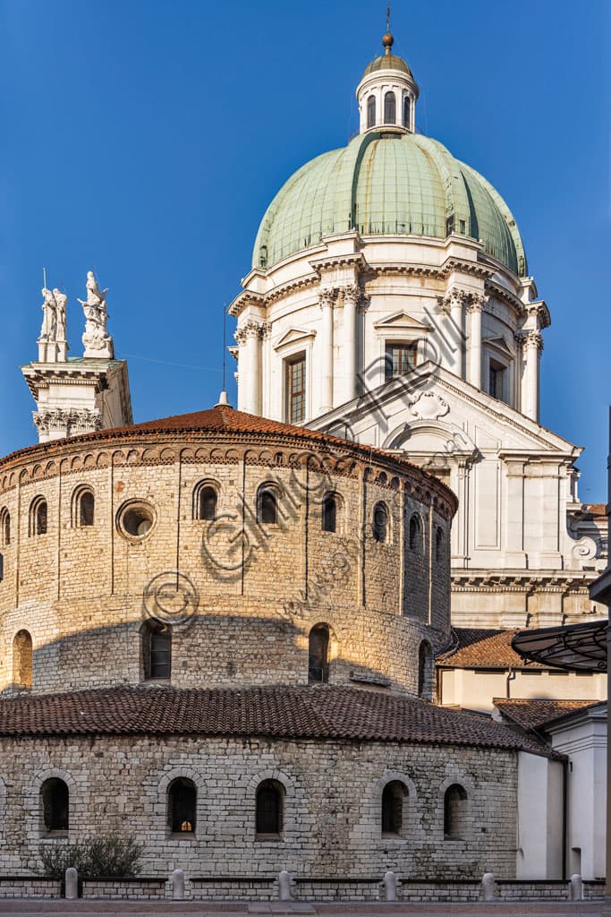 Alley in the historic centre of Brescia with view of the New Cathedral dome and the cylindrical structure of the Old Cathedral, both dedicated to Santa Maria Assunta