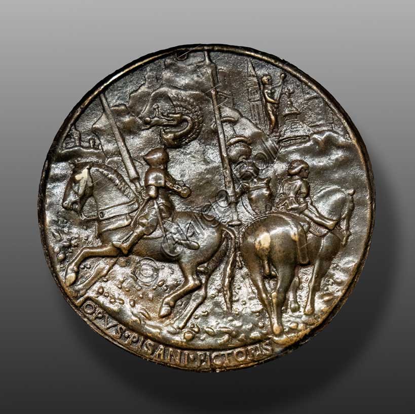 “Filippo Maria Visconti in Arms with his Squires”, bronze medal, by Pisanello (Antonio di Puccio Pisano), 1441. Reverse.Visconti wears a tall crest with a snake devouring a Saracen. The Torrazzo and the Baptistery of Cremona are probably represented in the architecture in the background.