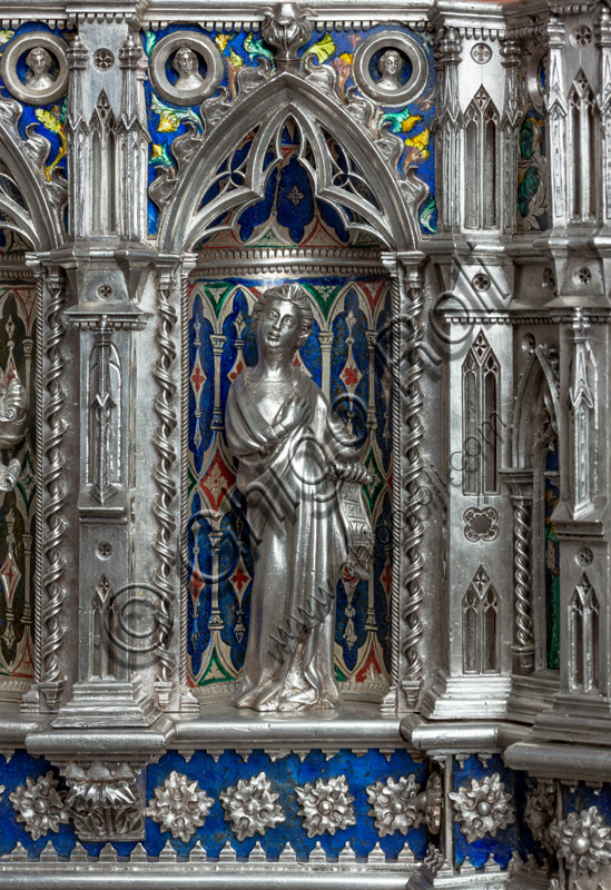 Florence, Museum of the Opera del Duomo (Museum of Florence Cathedral of Santa Maria del Fiore): “the silver altar of St. John's Treasure” (1367 - 1483), by florentine masters.Front of the dossal, fifth upper row: niche with a statue of a saint holding a parchment.