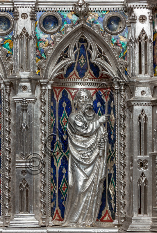 Florence, Museum of the Opera del Duomo (Museum of Florence Cathedral of Santa Maria del Fiore): “the silver altar of St. John's Treasure” (1367 - 1483), by florentine masters.Front of the dossal, fourth upper row: niche with a statue of a saint holding a scroll and pointing.