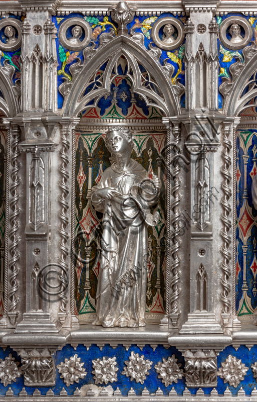 Florence, Museum of the Opera del Duomo (Museum of Florence Cathedral of Santa Maria del Fiore): “the silver altar of St. John's Treasure” (1367 - 1483), by florentine masters.Front of the dossal, fifth upper row: niche with a statue of a saint holding a parchment.