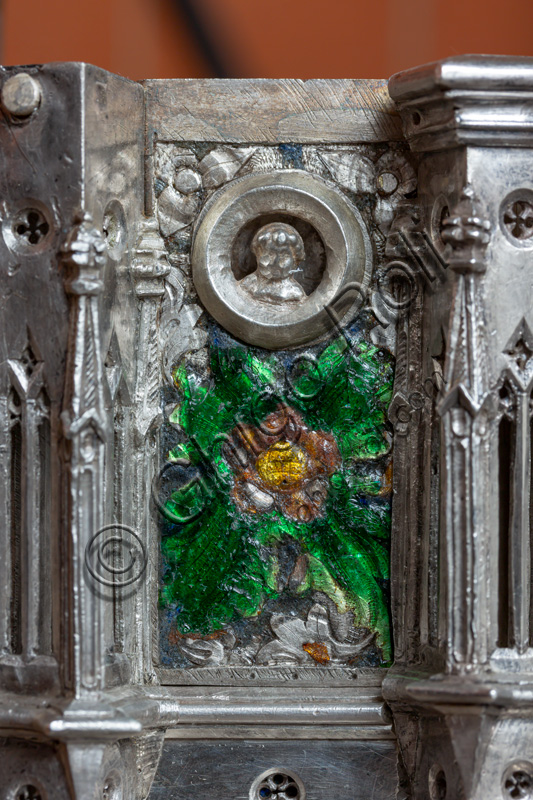 Florence, Museum of the Opera del Duomo (Museum of Florence Cathedral of Santa Maria del Fiore): “the silver altar of St. John's Treasure” (1367 - 1483), by florentine masters.Detail with enamel floral motifs and head within clypeus.