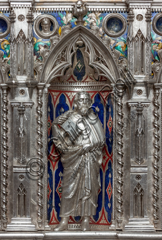 Florence, Museum of the Opera del Duomo (Museum of Florence Cathedral of Santa Maria del Fiore): “the silver altar of St. John's Treasure” (1367 - 1483), by florentine masters.Front of the dossal, fourth upper row: niche with a statue of a saint holding a parchment.