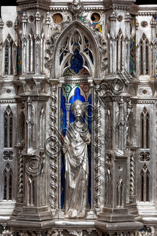 Florence, Museum of the Opera del Duomo (Museum of Florence Cathedral of Santa Maria del Fiore): “the silver altar of St. John's Treasure” (1367 - 1483), by florentine masters.Front of the dossal: upper detail of the fourth pillar with a statuette of a saint holding a scroll, within a niche.