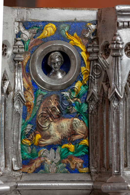 Florence, Museum of the Opera del Duomo (Museum of Florence Cathedral of Santa Maria del Fiore): “the silver altar of St. John's Treasure” (1367 - 1483), by florentine masters.Front of the dossal: upper detail of the fourth pillar with a lion holding a sphere between its legs (Medici Lion?), floral enamel motifs and head within clypeus.