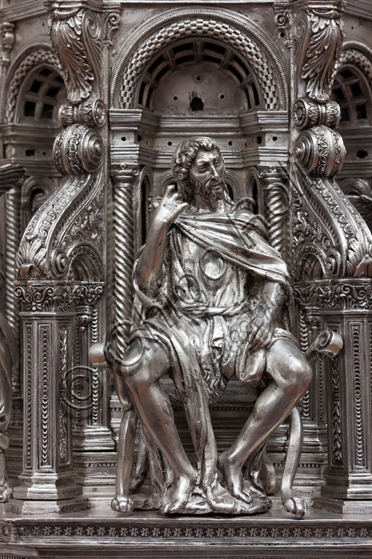 Florence, Museum of the Opera del Duomo (Museum of Florence Cathedral of Santa Maria del Fiore): “The Cross of the Treasure of St. John: the verso.”Detail of ”statue of St. John the Baptist ".The Cross  is a splendid example of Renaissance jewelery, sculpted in silver foil, chiseled and enameled by Betto di Francesco Betti, Antonio del Pollaiolo and Miliano di Domenico Dei between 1457 and 1459 approximately. It was commissioned to complete the silver altar. The Cross-monstrance is made up of three distinct main parts: the Crucifix, the stem and the base. 