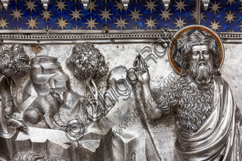 “St John the Baptist preaches to the crowds”, by fourteenth-century Florentine goldsmiths. St. John holds up the motto: "Vos clamantes in the desert, parate viam Domini".Tile of “The Silver Altar of St. John's Treasure” (1367 - 1483), Museum of the Opera del Duomo (Museum of Florence Cathedral of Santa Maria del Fiore), Florence.Detail with the Saint, trees and an animal.