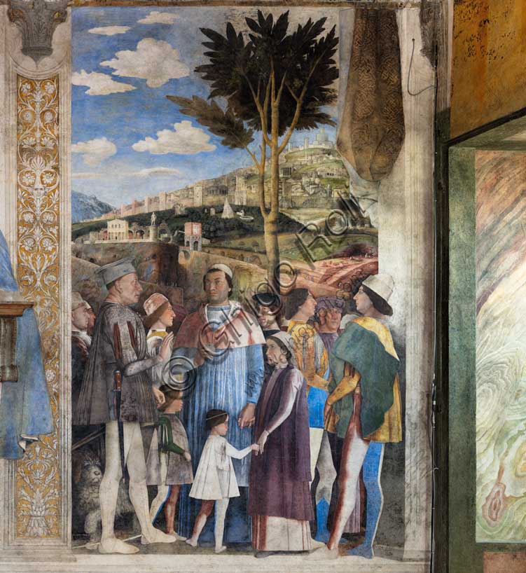 Ducal Palace: south-west wall of the “Bridal Chamber or Camera Picta", which is a room located in the north-east tower of the Castle of San Giorgio in Mantua. It is famous for the cycle of frescoes that covers its walls, a masterpiece by Andrea Mantegna, created between 1465 and 1474.The wall, on the theme of “The Meeting” is divided into three sectors. In the one on the left the actual meeting takes place, in the central one some cherubs hold a dedicatory plaque and in the one on the right the marquis's court parades.Detail of the right part of the wall.The Marquis Ludovico is represented in the Meeting, this time in official guise, perhaps flanked by Ugolotto Gonzaga, son of his deceased brother Carlo. His son Francesco who is a Cardinal is in front of him. Below them are the sons of Federico I Gonzaga, Francesco and Sigismondo, while their father Federico is on the far right: the generous folds of his dress are a ploy to hide his kyphosis. Federico is in conversation with two characters, one in front and the other in the background, indicated by some as Christian I of Denmarkand Frederick III of Habsburg, figures who well represent the family's pride in royal kinship. Finally, the boy in the center is the last son of the marquis, the prothonotary Ludovico. In the background an ideal view of Rome is represented, in which there ancient monuments such as the Colosseum, Castel Sant'Angelo, the pyramid of Cestius, the theater of Marcellus, the Nomentano bridge, the Aurelian Walls, etc. cani be recognised. Mantegna also invented some monuments  such as a colossal statue of Hercules. On the right there is also a cave where some quarrymen are at work sculpting blocks and columns.