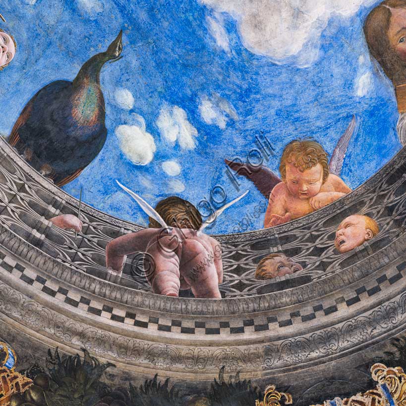 Palazzo Ducale: volta della  “Camera degli Sposi o Camera Picta”, che è una stanza collocata nel torrione nord-est del Castello di San Giorgio di Mantova. È celebre per il ciclo di affreschi che ricopre le sue pareti, capolavoro di Andrea Mantegna, realizzato tra il 1465 e il 1474. Particolare dell’ oculo della volta dove si vede una balaustra dalla quale si sporgono alcuni putti e un pavone.