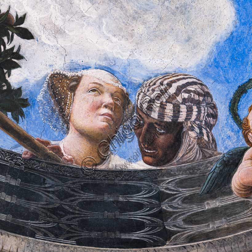 Palazzo Ducale: volta della  “Camera degli Sposi o Camera Picta”, che è una stanza collocata nel torrione nord-est del Castello di San Giorgio di Mantova. È celebre per il ciclo di affreschi che ricopre le sue pareti, capolavoro di Andrea Mantegna, realizzato tra il 1465 e il 1474. Particolare dell’ oculo della volta dove si vede una balaustra dalla quale si sporgono una dama di corte, accompagnata dalla serva di colore. 