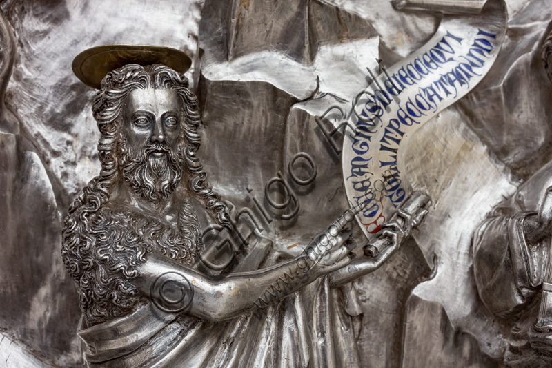 “St. John the Baptist indicates Christ to the disciples”, by fourteenth-century Florentine goldsmiths. The Saint holds up the motto: “Ecce Agnus Dei, exception Qui tollit peccata mundi”.Tile of “The Silver Altar of St. John's Treasure” (1367 - 1483), Museum of the Opera del Duomo (Museum of Florence Cathedral of Santa Maria del Fiore), Florence.Detail.