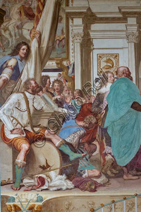 Villa medicea La Petraia, cortile:  “Cosimo I associa al governo il figlio Francesco”, affresco del ciclo dei Fasti Medicei del Volterrano (Baldassarre Franceschini), 1636-1647.Ambientata nel Salone dei Cinquecento in palazzo Vecchio, la scena mostra Cosimo I che protende a suo figlio Francesco in trono la nomina che lo associa al governo. Francesco riceve quindi l'omaggio dei senatori fiorentini, tra una variegata folla di astanti. Sulla parete si vedono la tartaruga del Festina lente, emblema di Cosimo e, anacronisticamente, il rinoceronte, che sarà l'emblema dell'altro figlio di Cosimo, Ferdinando I. Le statue della Pace e dell'Abbondanza, ai lati del trono, rappresentano un buon auspicio sul nuovo governo, vicino a funzionari di corte che versano sacchi di monete in un forziere. A sinistra si vede in primo piano un guerriero, seduto con espressione trasognata su un tamburo da guerra sfondato, perché non dovrà più suonare. Particolare.