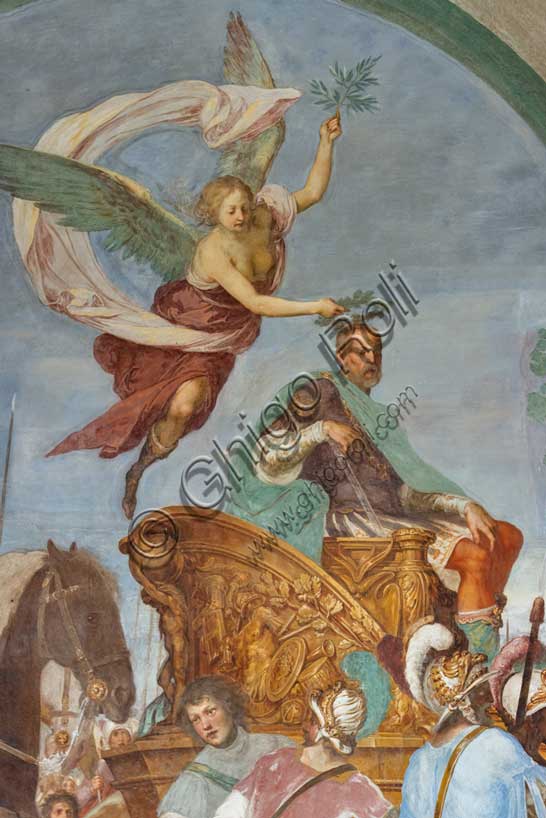 Medici Villa La Petraia, courtyard: “Triumphal entry of Cosimo I into Siena”, fresco from the cycle of the Fasti Medicei by Volterrano (Baldassarre Franceschini), 1636-1647.In 1555 Cosimo I de' Medici conquered Siena with the help of the Imperials, a military feat which later earned him the title of Grand Duke, therefore a crucial moment for the Medici house. The fresco, with clear celebratory intentions, shows Cosimo making his triumphal entry into the city gates on a golden chariot, followed by a large group of dignitaries, welcomed by the Sienese senators and some citizens. Detail of a winged Victory who  crowns Cosimo I with a laurel wreath.